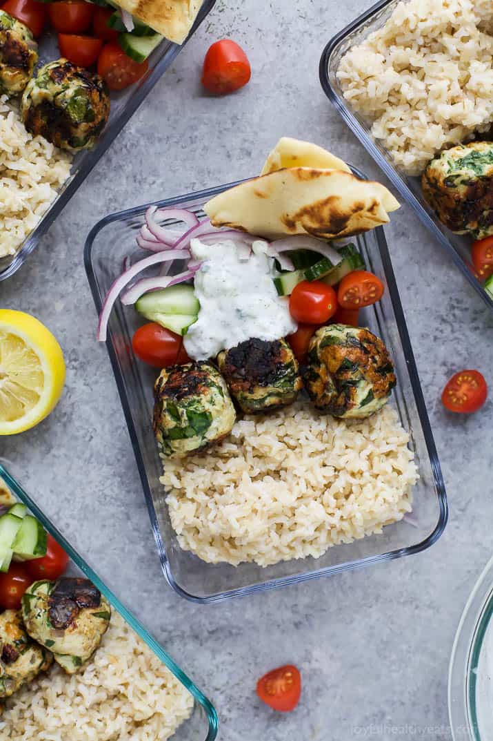 Top view of a Gyro Turkey Meatball Grain Bowl with rice, vegetables, pita bread and a creamy Tzatziki sauce