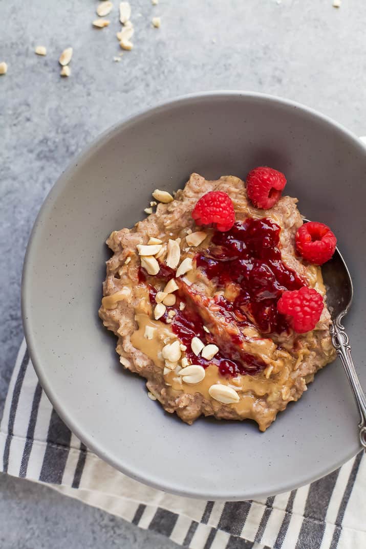 A bowl of Homemade Peanut Butter & Jelly Oatmeal with fresh raspberries