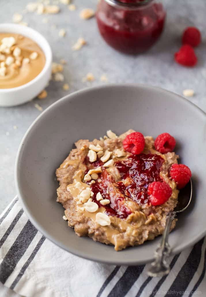 A bowl of Peanut Butter & Jelly Oatmeal with Raspberries and Peanuts