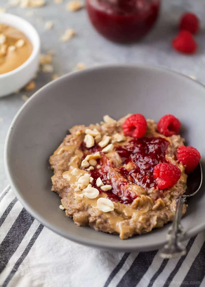 A bowl of Peanut Butter & Jelly Oatmeal with fresh raspberries