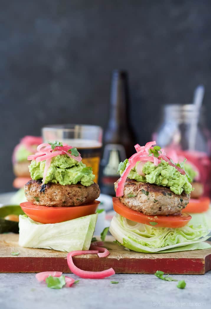 Healthy Paleo Chipotle Turkey Burgers filled with tex-mex flavor then topped with zesty guacamole and pickled onions. These Turkey Burgers are low carb, high in protein, done in 30 minutes and guaranteed to be a favorite!