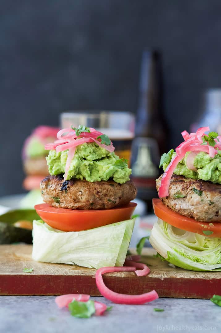 Healthy Paleo Chipotle Turkey Burgers filled with tex-mex flavor then topped with zesty guacamole and pickled onions. These Turkey Burgers are low carb, high in protein, done in 30 minutes and guaranteed to be a favorite!