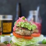 Healthy Paleo Chipotle Turkey Burgers filled with tex-mex flavor then topped with zesty guacamole and pickled onions. These Turkey Burgers are low carb, high in protein, done in 30 minutes and guaranteed to be a favorite!