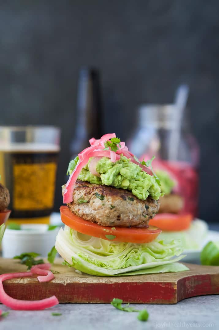 Healthy Paleo Chipotle Turkey Burgers filled with tex-mex flavor then topped with zesty guacamole and pickled onions. These Turkey Burgers are low carb, high in protein, done in 30 minutes and guaranteed to be a favorite!