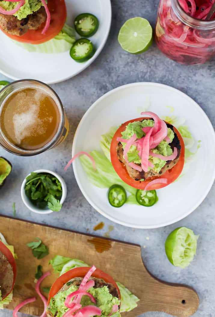 Healthy Paleo Chipotle Turkey Burgers filled with tex-mex flavor then topped with zesty guacamole and pickled onions. These Turkey Burgers are low carb, high in protein, done in 30 minutes and guaranteed to be a favorite!