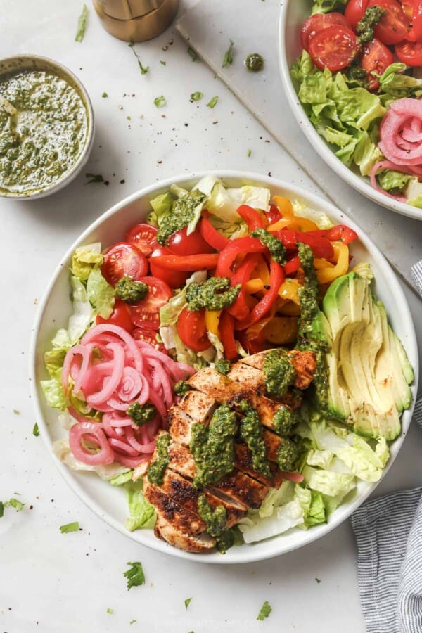 Bowl of chicken fajita salad with herby dressing.