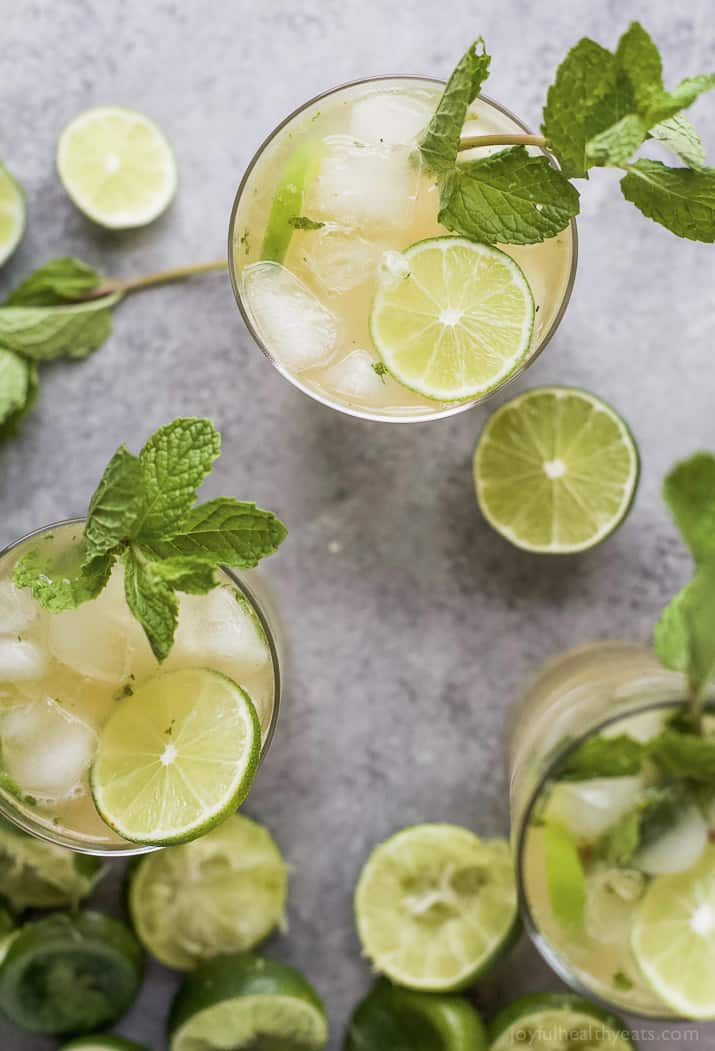 Top view of several glasses of Mojito with mint and lime garnish