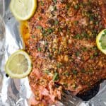 Easy Paleo Honey Mustard Baked Salmon in tin foil for easy cleanup. This sweet and spicy Baked Salmon is less than 200 calories, high in protein and done in less than 30 minutes!