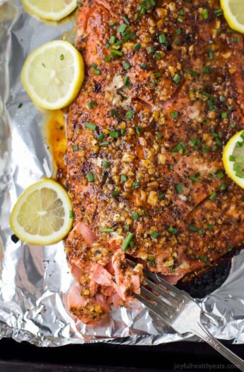 Easy Paleo Honey Mustard Baked Salmon in tin foil for easy cleanup. This sweet and spicy Baked Salmon is less than 200 calories, high in protein and done in less than 30 minutes!