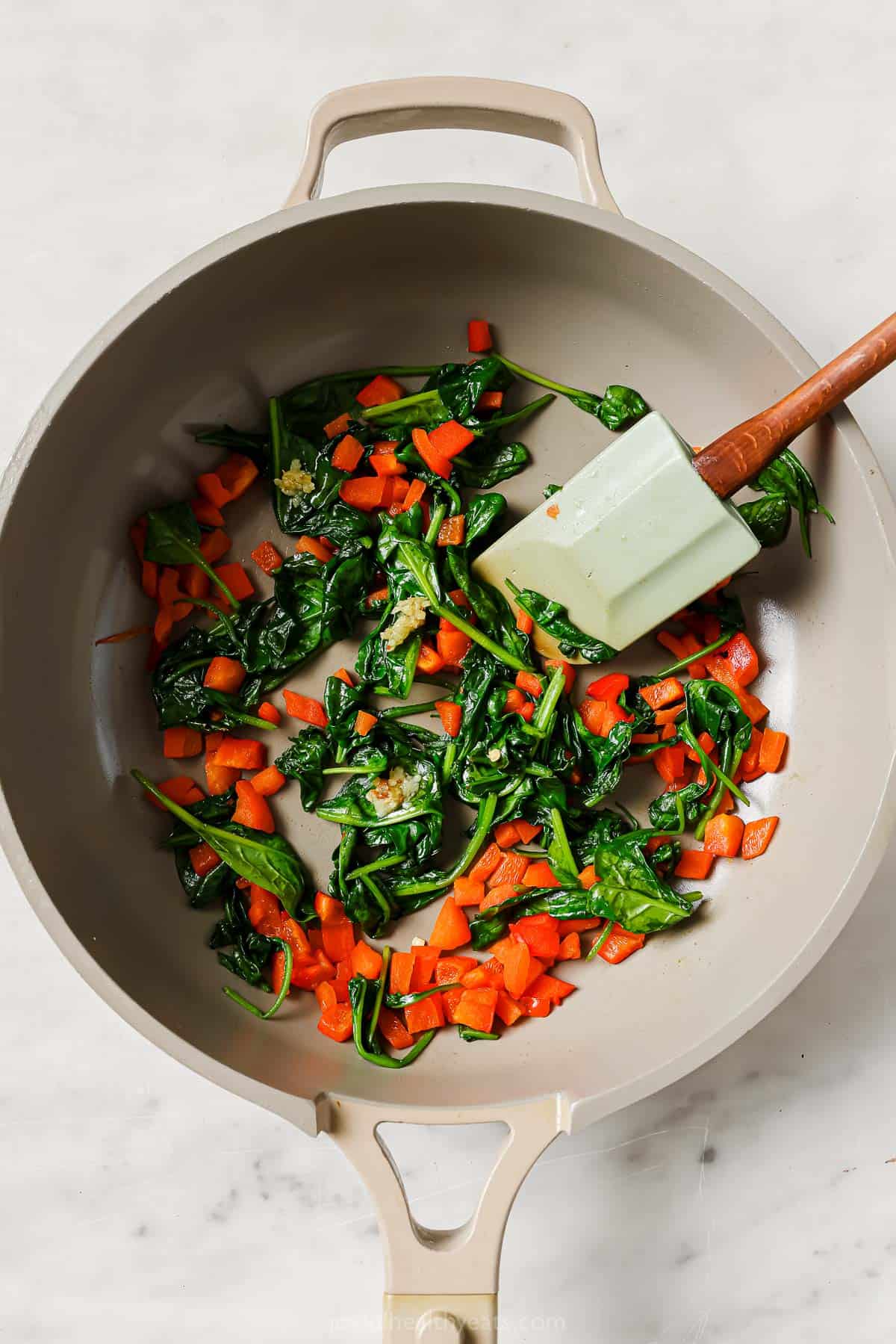 Cooking the spinach-red pepper filling. 