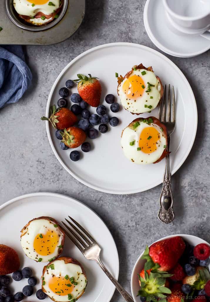 PROSCIUTTO BAKED EGG CUPS with fresh fruit on a plate