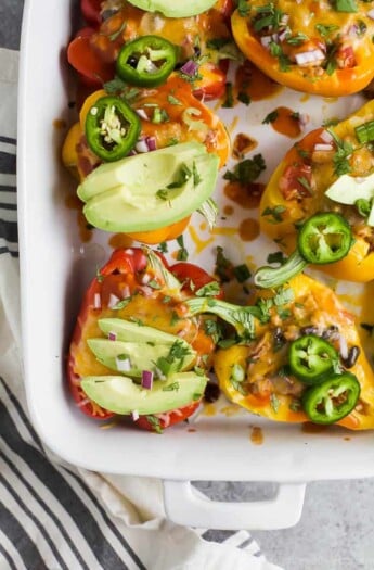 Cheesy Turkey Enchilada Stuffed Peppers filled with tex-mex flavor and covered in melty cheese. These gluten free Stuffed Peppers make an absolutely delicious healthy weeknight dinner for the family.