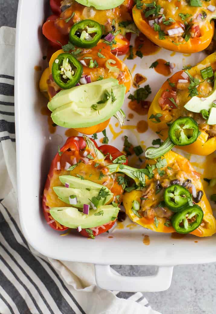 Cheesy Turkey Enchilada Stuffed Peppers filled with tex-mex flavor and covered in melty cheese. These gluten free Stuffed Peppers make an absolutely delicious healthy weeknight dinner for the family.