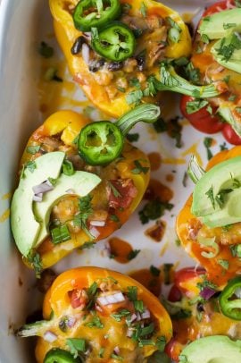 turkey enchilada stuffed peppers with avocado and jalapeno on top