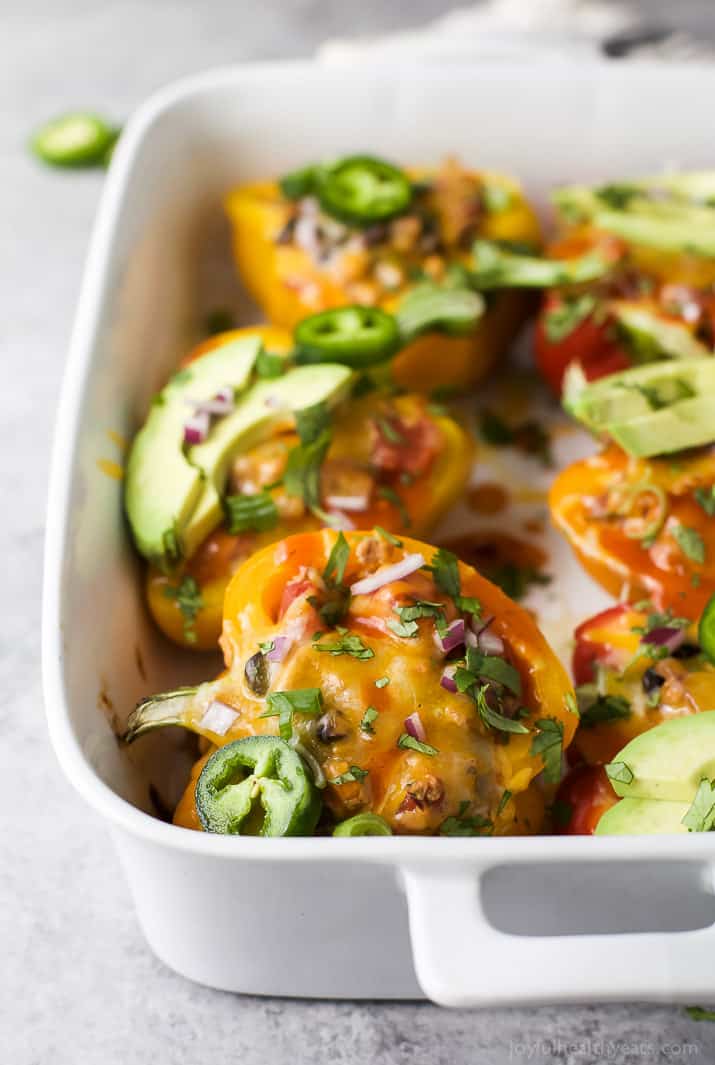 Cheesy Turkey Enchilada Stuffed Peppers filled with tex-mex flavor and covered in melty cheese. These gluten free Stuffed Peppers make an absolutely delicious healthy weeknight dinner for the family.