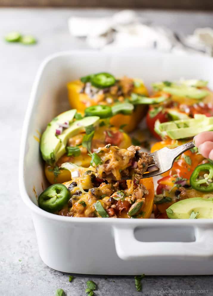 Cheesy Turkey Enchilada Stuffed Peppers filled with tex-mex flavor and covered in melty cheese. These gluten free Stuffed Peppers make an absolutely delicious healthy weeknight dinner for the family.