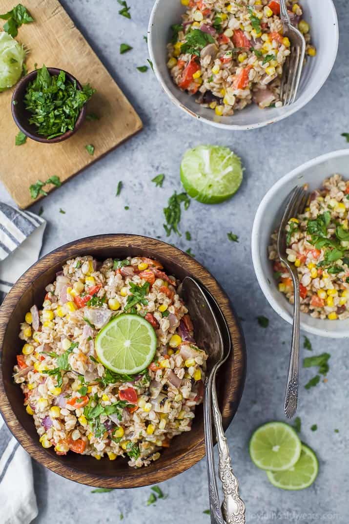 Top view of bowls of Farro Salad filled with Char Grilled Corn, Roasted Red Pepper and creamy goat cheese