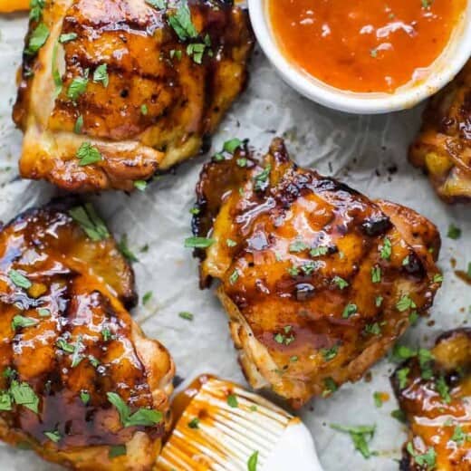 chipotle apricot glazed chicken thighs on a parchment paper