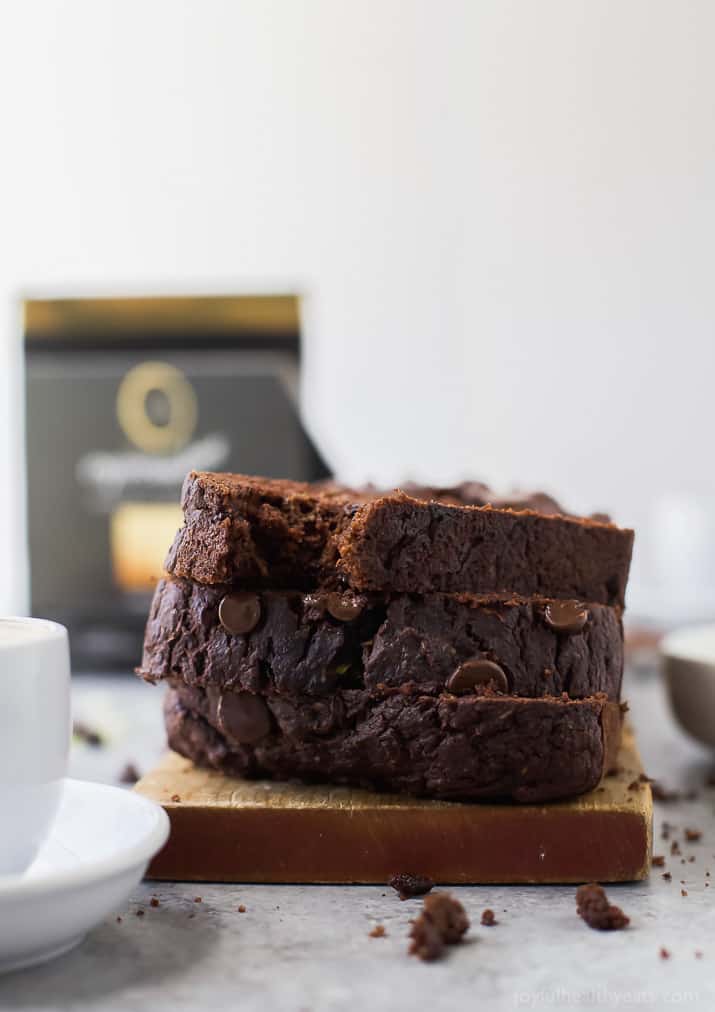 Slices of Double Chocolate Zucchini Bread stacked on a wooden board