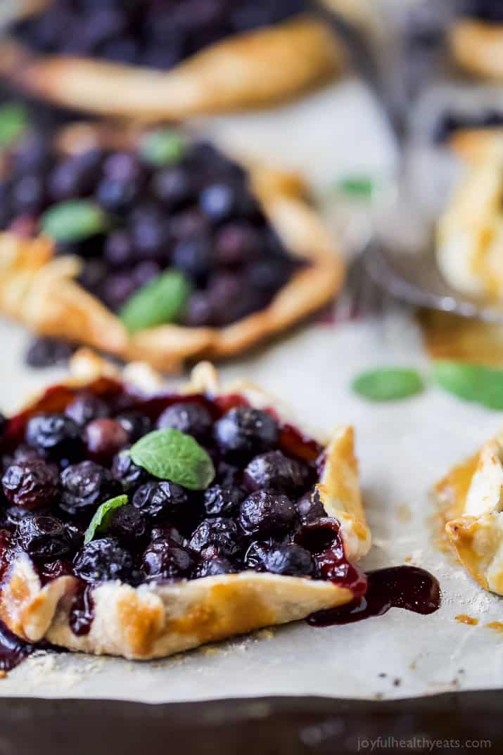 Close-up of Fresh Mini Blueberry Galettes on parchment paper