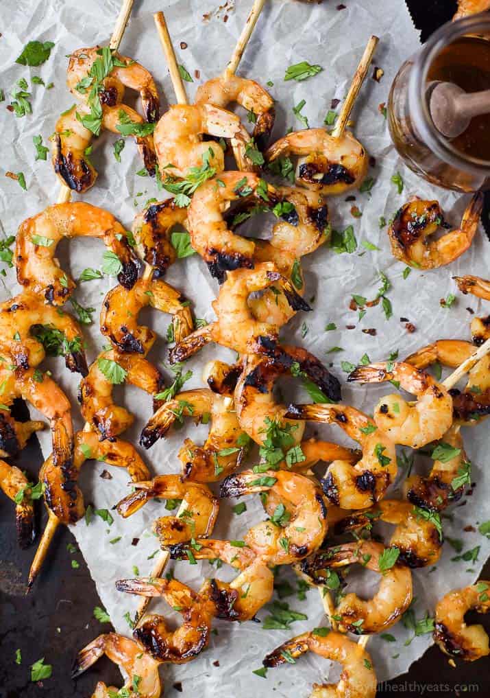 Easy 30 Minute Honey Garlic Grilled Shrimp with only 4 ingredients and full of bold flavors. These grilled shrimp will be a favorite this summer - I guarantee you'll be licking your fingers!