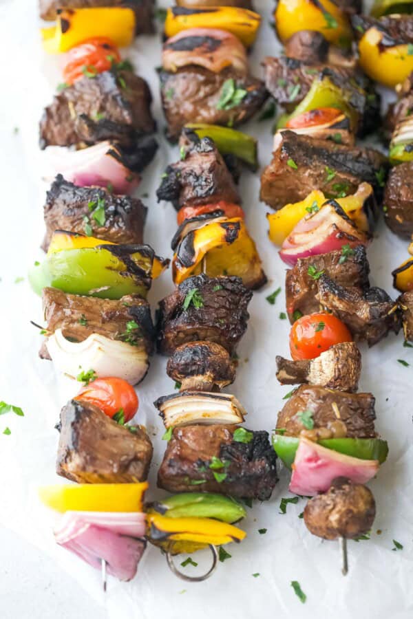 Perfectly charred, juicy beef kabobs with bell peppers, onions, tomatoes, and mushrooms.