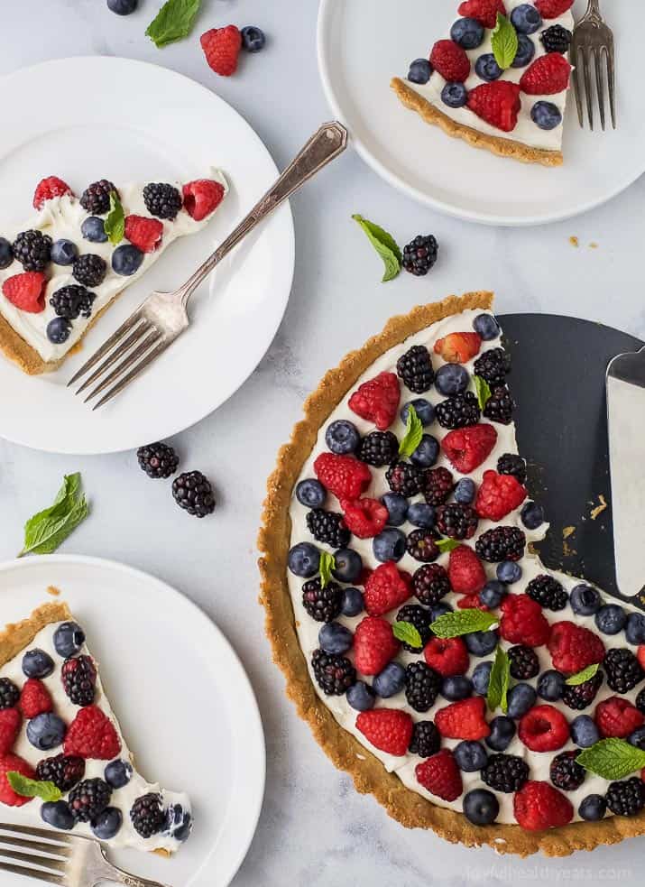 Berry Tart filled with a creamy greek yogurt cheesecake filling and an Almond Crust