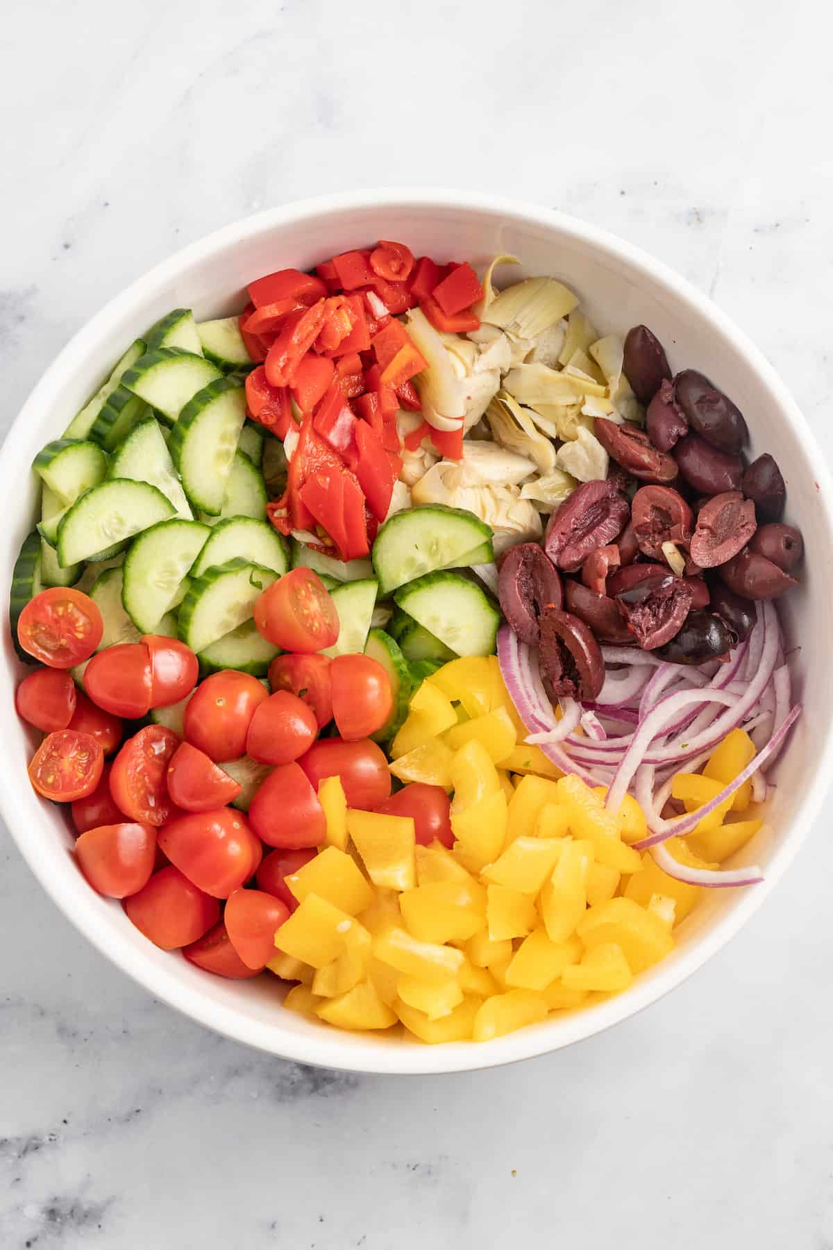 Adding the veggies to a mixing bowl. 