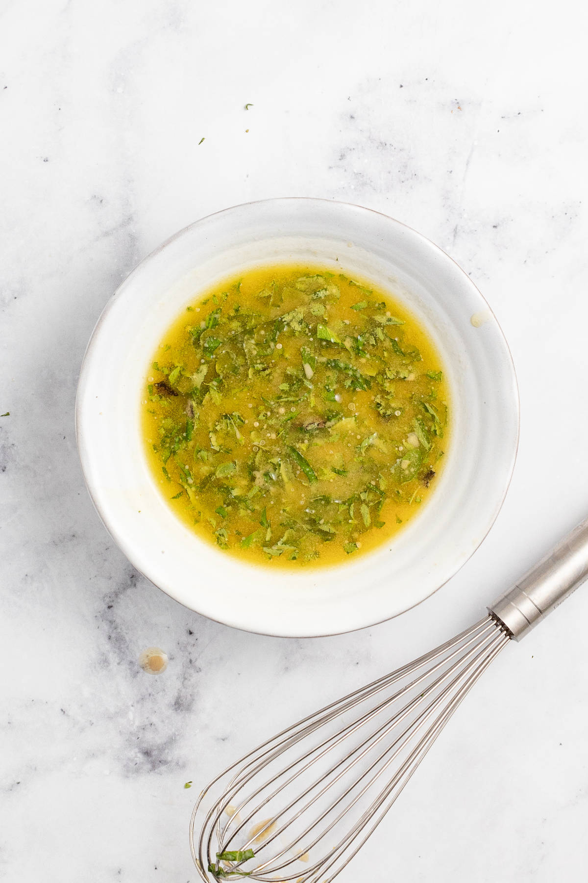 Whisked dressing in a bowl. 