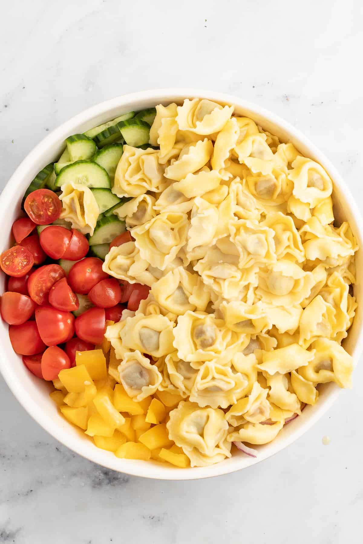 Adding the chilled tortellini to the veggies. 