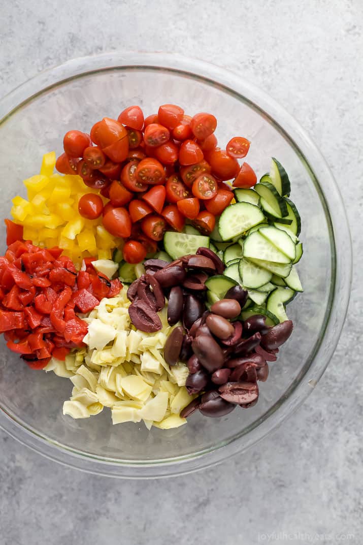 Top view of veggies for Greek Tortellini Salad in a mixing bowl