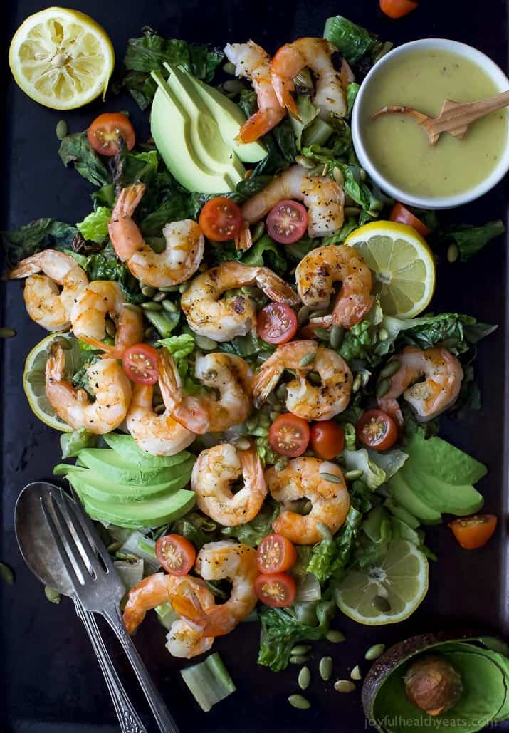 Top view of Grilled Shrimp Caesar Salad with sliced avocado and homemade Caesar dressing