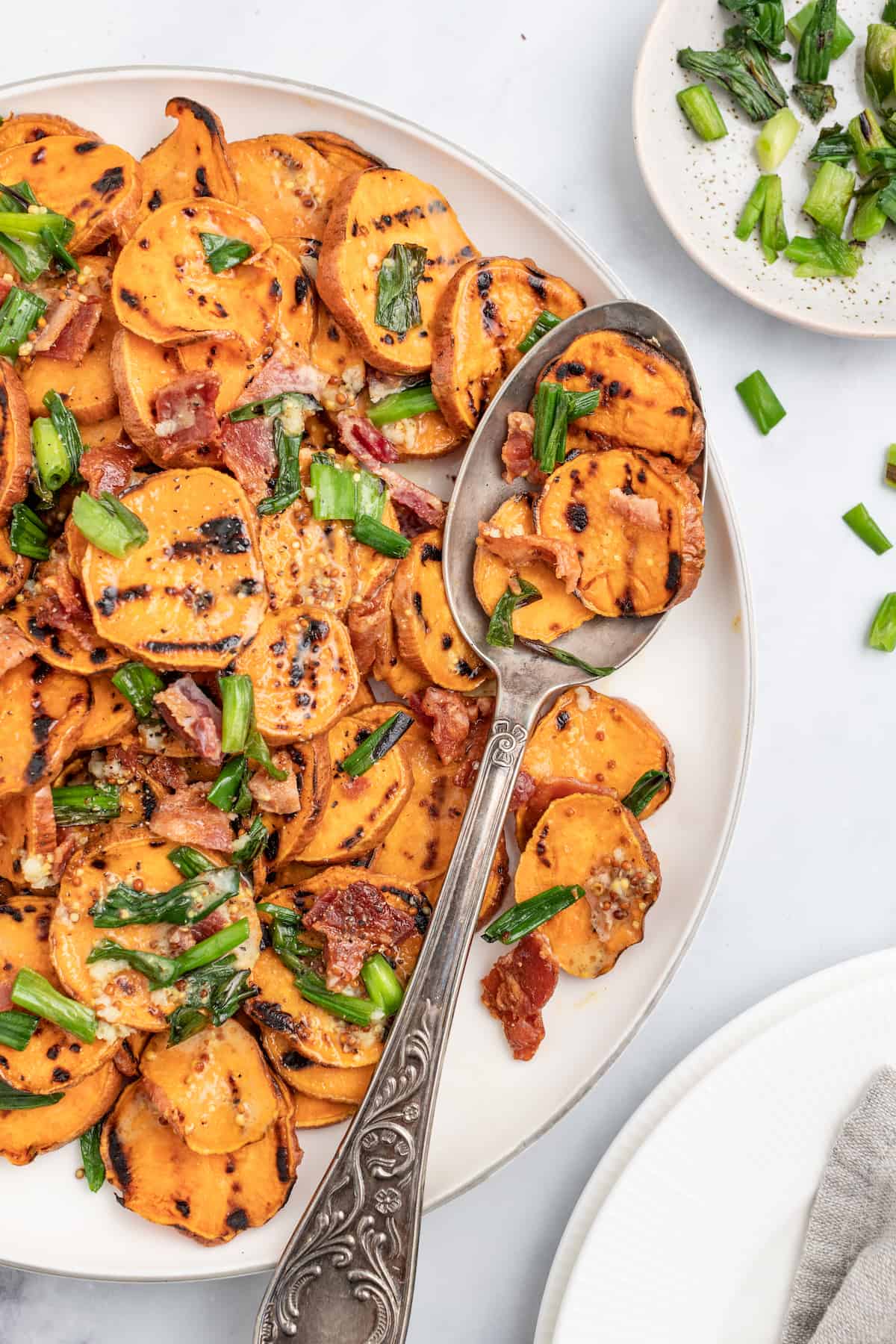 Healthy sweet potato salad with a spoon.