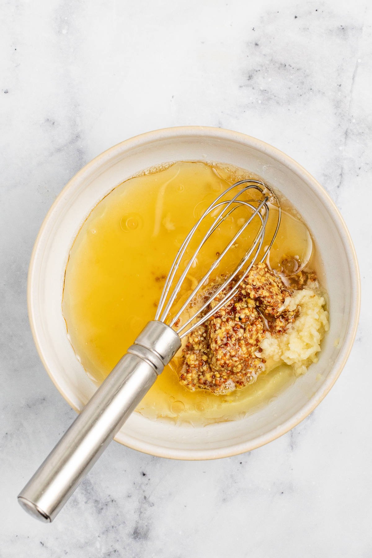 Adding the dressing ingredients to a mixing bowl.