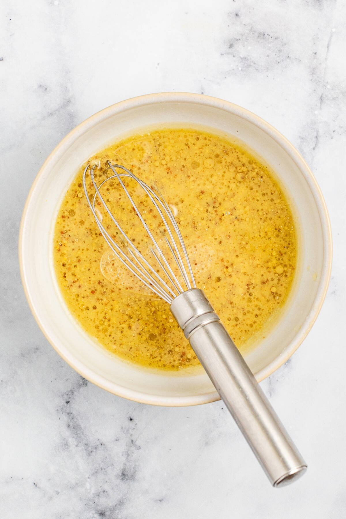 Whisked dressing in a bowl. 