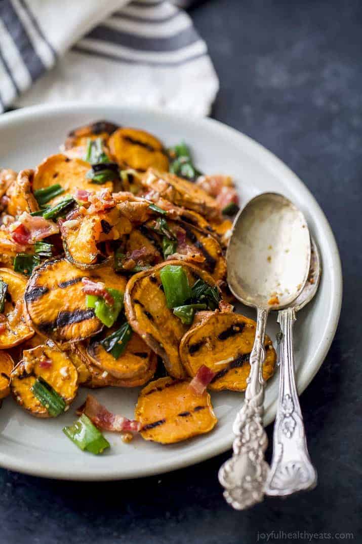 GRILLED SWEET POTATO SALAD with crispy bacon and grilled scallions on a plate
