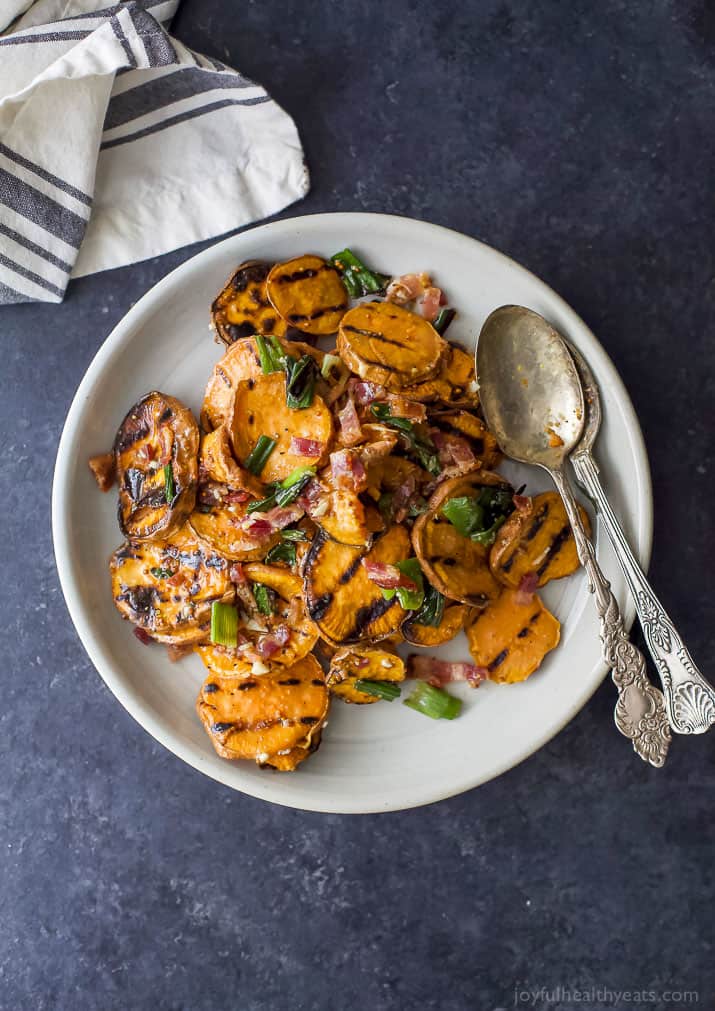 Top view of GRILLED SWEET POTATO SALAD with crispy bacon and grilled scallions on a plate