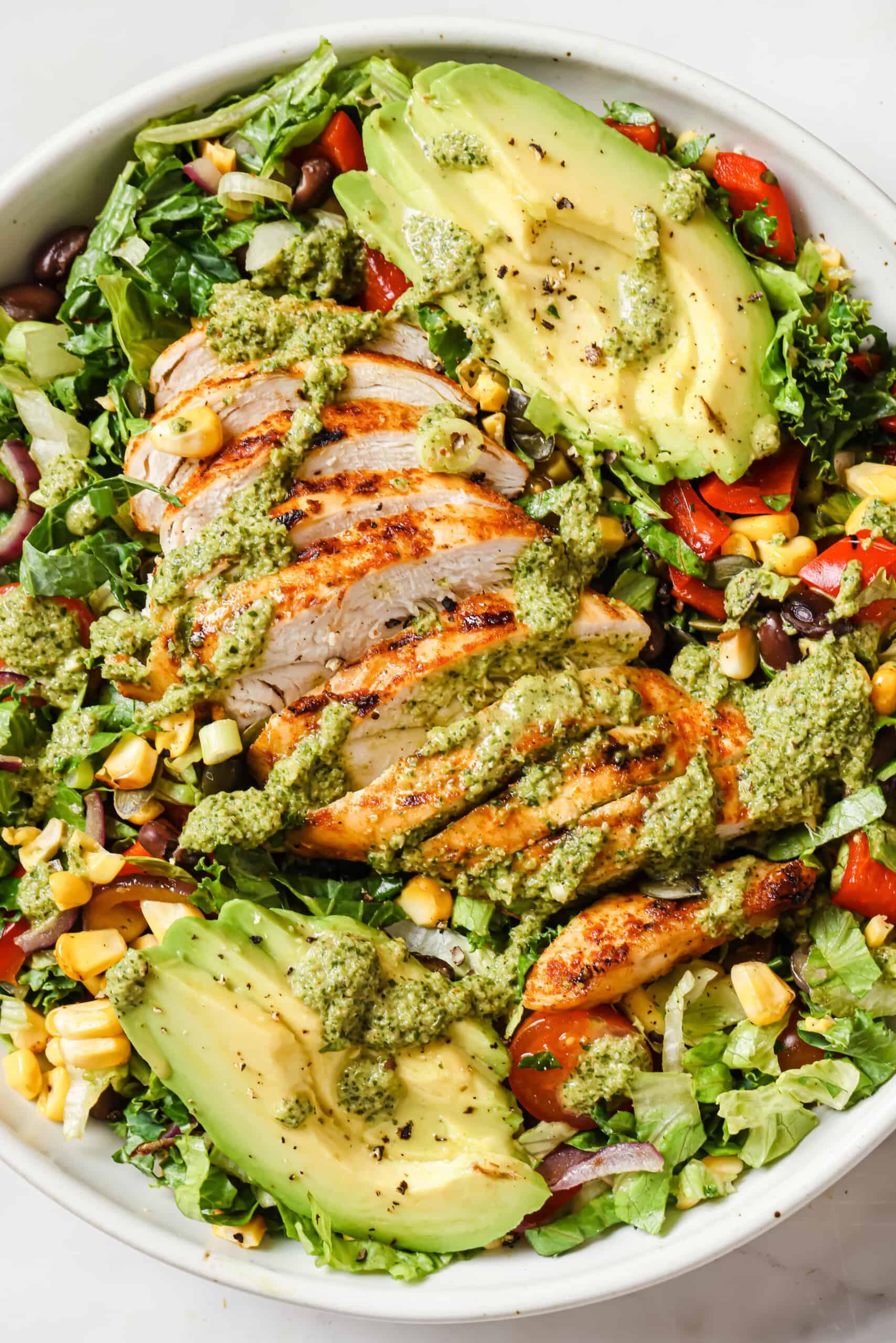 Chicken chopped salad with avocado and dressing. 