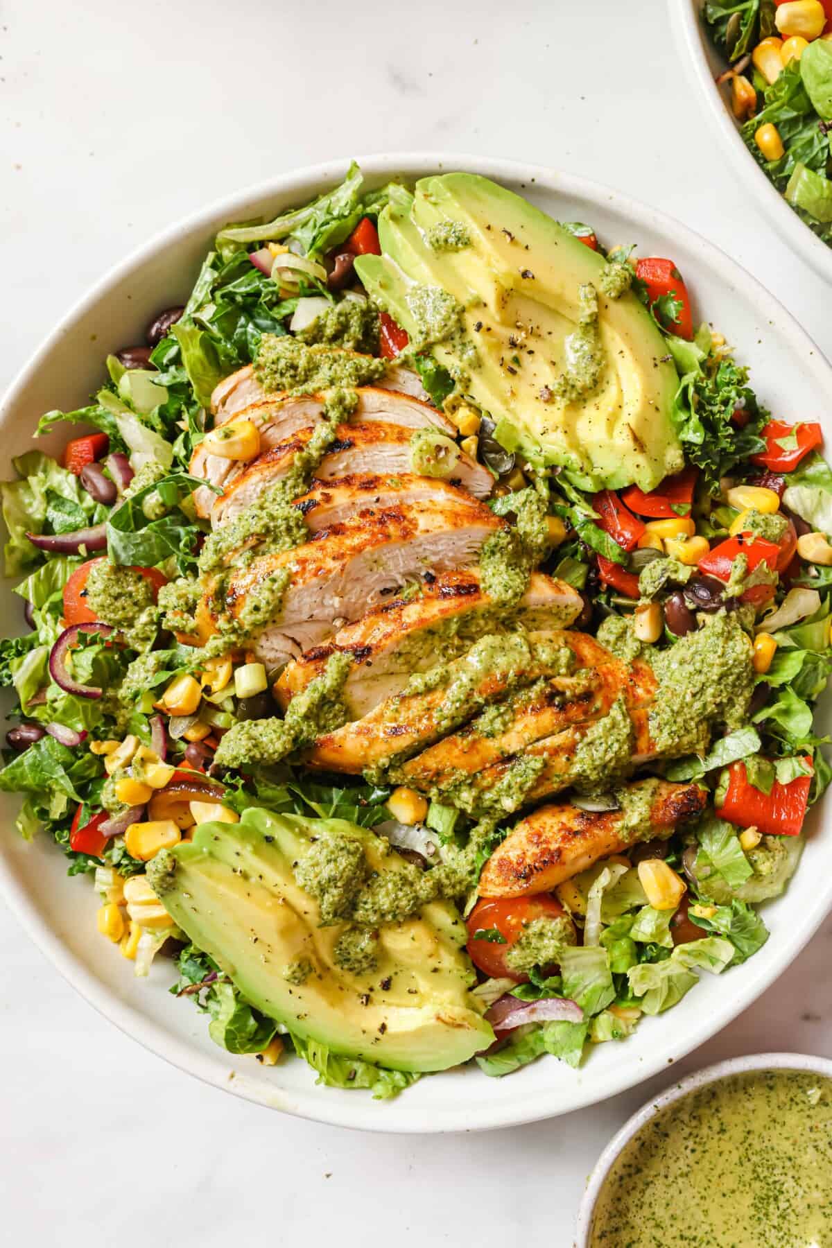 Bowl of Mexican chopped salad with dressing.