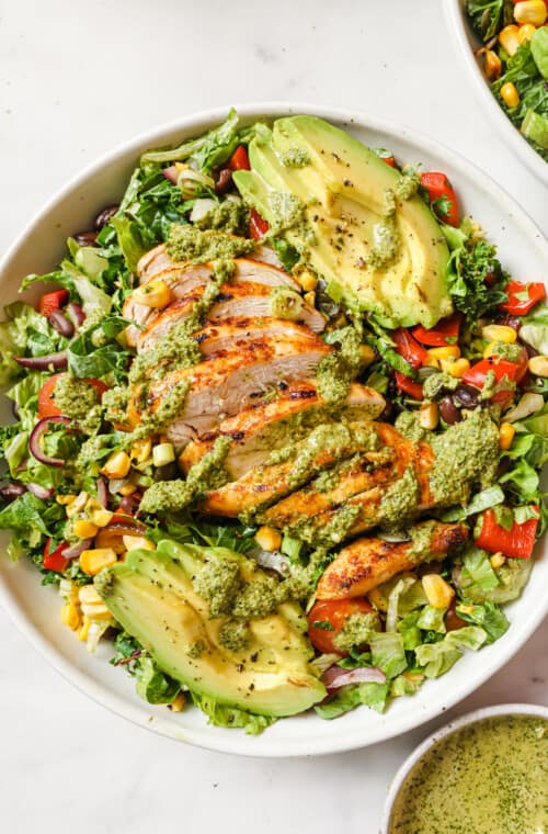 Bowl of Mexican chopped salad with dressing.