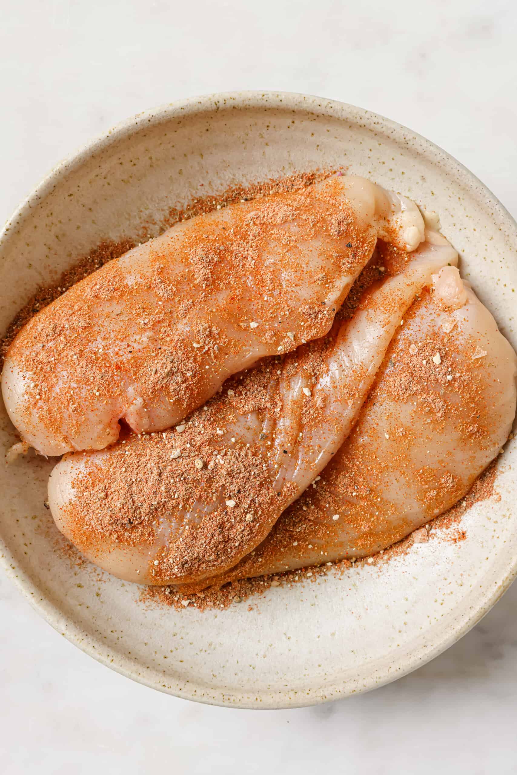 Raw chicken coated in the spice mix. 