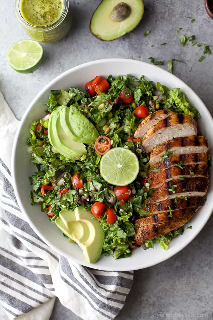 A large white bowl filled with Mexican Chopped Salad with grilled chicken and avocados