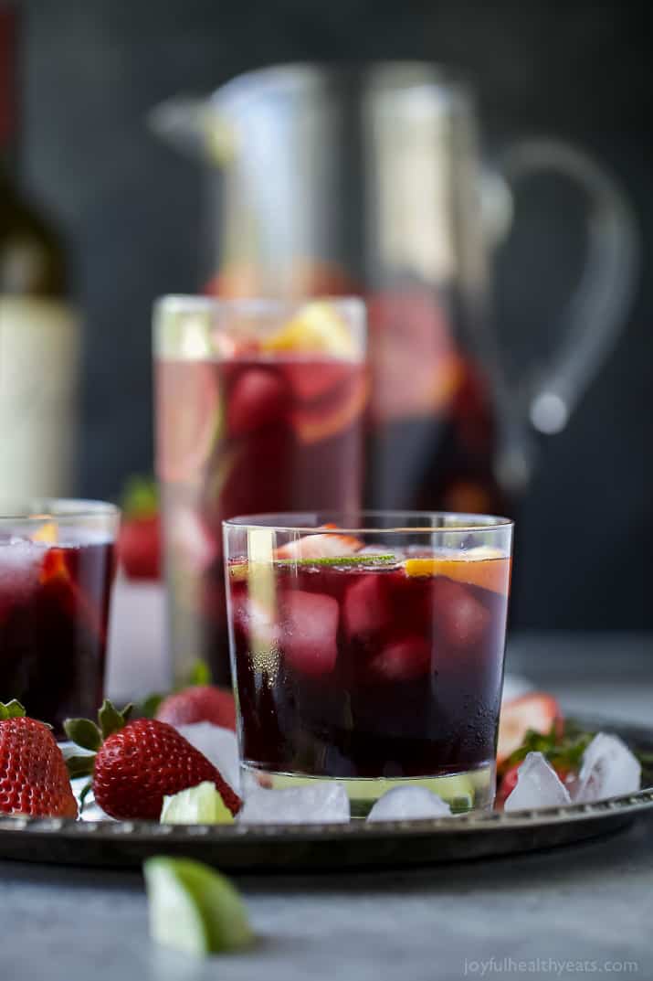 Strawberry Summer Sangria filled with fresh strawberries, peaches and loads of citrus! This Summer Sangria served over ice is a light refreshing cocktail you'll want around at your next party!