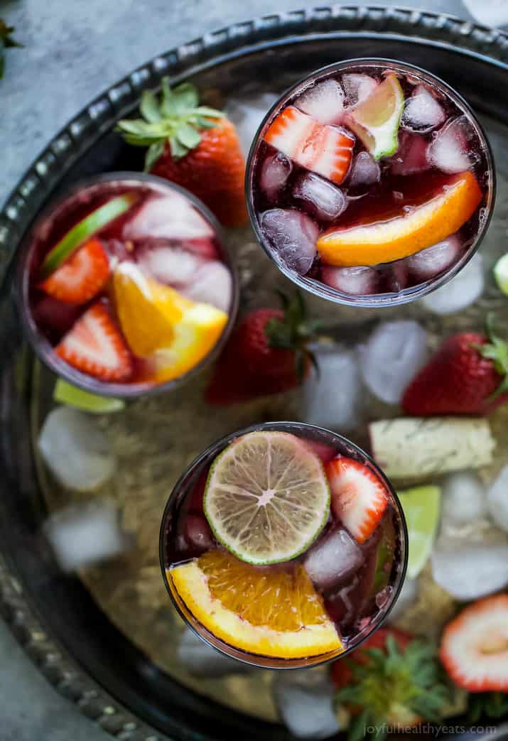 Strawberry Summer Sangria filled with fresh strawberries, peaches and loads of citrus! This Summer Sangria served over ice is a light refreshing cocktail you'll want around at your next party!