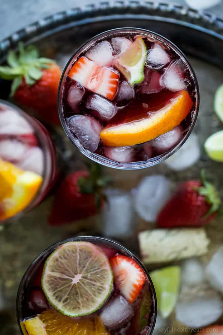 Strawberry Summer Sangria filled with fresh strawberries, peaches and loads of citrus! This Summer Sangria served over ice is a light refreshing cocktail you'll want around at your next party!