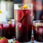 Strawberry Summer Sangria filled with fresh strawberries, peaches and loads of citrus! This Summer Sangria served over ice is a light refreshing cocktail you'll want around at your next party!