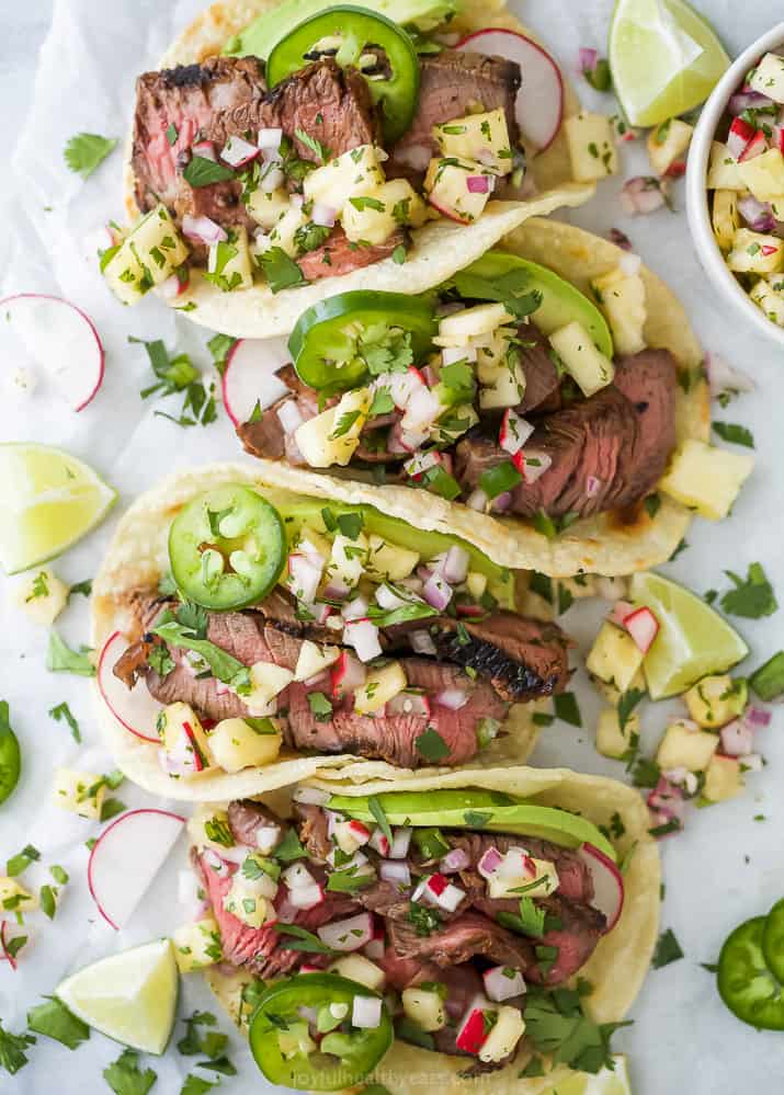 closeup of marinated steak tacos and pineapple salsa