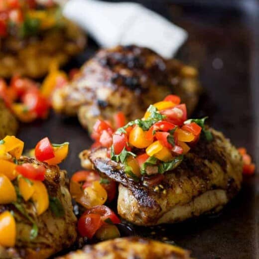 Balsamic Grilled Chicken Thighs topped with a fresh tomato Bruschetta. An easy 30 minute meal that will quickly become the ultimate grilling recipe you'll want all summer! #ad #glutenfree #paleo