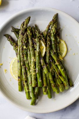Grilled Asparagus topped with fresh Lemon zest, an easy paleo side dish that screams summer and takes minutes to make. You'll love how easy and flavorful this recipe is! 
