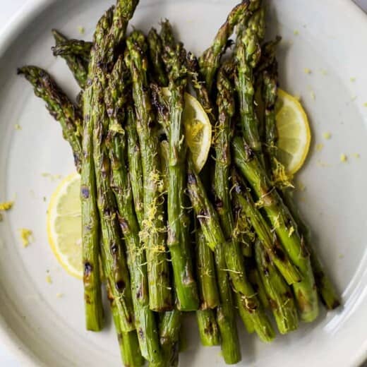 Grilled Asparagus topped with fresh Lemon zest, an easy paleo side dish that screams summer and takes minutes to make. You'll love how easy and flavorful this recipe is! 